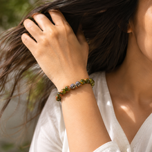 Load image into Gallery viewer, Woman wearing Unakite Stone Silver Bead Bracelet 8MM by MysticFlavia featuring natural unakite gemstone beads and decorative silver beads in a lifestyle setting.
