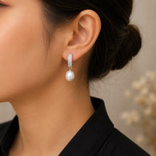 Load image into Gallery viewer, Model wearing elegant silver pearl drop earrings with round white pearls for a refined look.
