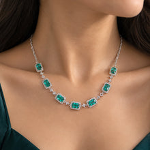 Load image into Gallery viewer, Emerald gemstone silver necklace worn on a model, featuring rectangular green stones and floral detailing by MysticFlavia
