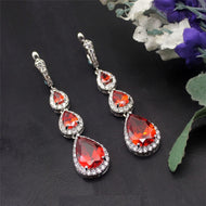 Red Gemstone Teardrop Sterling Silver Earrings on Black Background
