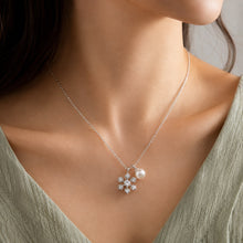 Load image into Gallery viewer, Silver pearl pendant necklace worn on a model, featuring a delicate floral crystal pendant

