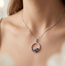 Load image into Gallery viewer, Woman wearing Zurich Azure circle pendant crystal silver necklace with blue crystal circle pendant
