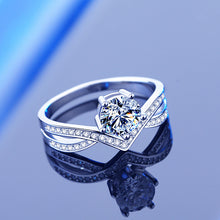 Load image into Gallery viewer, 925 sterling silver moissanite ring with a brilliant center stone and detailed crossover setting
