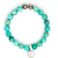 Amazonite silver bead bracelet with teal-green beads, two carved silver beads on top and round silver brand charm pendant, white background
