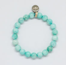 Load image into Gallery viewer, MysticFlavia amazonite bracelet with mint green beads and silver brand charm at top, flat lay on white background

