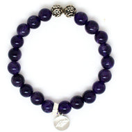 Amethyst bracelet with round purple beads and silver charm on a clean white background by MysticFlavia