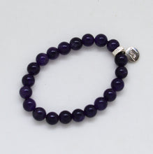 Load image into Gallery viewer, Flat lay of round amethyst stone bracelet with silver charm on white background
