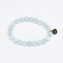 Load image into Gallery viewer, MysticFlavia Aquamarine Birthstone bracelet with clear light blue flat beads and dark round brand charm, side view white background
