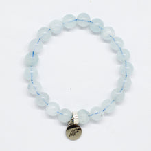 Load image into Gallery viewer, Aquamarine Birthstone flat silver bracelet with pale blue translucent beads and round silver brand charm pendant, white background
