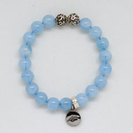 Aquamarine Birthstone super stone silver bracelet with bright blue round beads, two carved silver beads on top and round brand charm pendant, white background