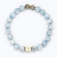 Aquamarine Birthstone bracelet with pale blue round beads, two carved silver beads on top and square infinity charm, white background
