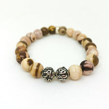 Load image into Gallery viewer, Angled view of Australian Zebra Stone Silver Bead Bracelet 8mm featuring natural Australian Zebra Stone and 925 Sterling Silver Om beads.
