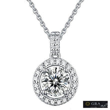 Load image into Gallery viewer, Moissanite halo pendant necklace in silver, close-up view showing round centre stone and pave border, GRA certified.
