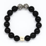 MysticFlavia black obsidian bracelet 12mm flat view with two engraved silver accent beads at top and white square infinity bead at bottom on white background
