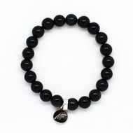 MysticFlavia black obsidian bracelet 8mm flat view with dark round brand charm pendant at bottom on white background

