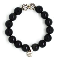 MysticFlavia black obsidian bracelet 12mm flat view with two engraved silver accent beads at top and round brand charm at bottom on white background
