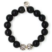 Load image into Gallery viewer, Black obsidian silver bead bracelet 12mm top view with round brand charm at top and two engraved silver beads at bottom on white background

