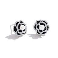 Round floral silver stud earrings displayed on white background