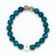 Load image into Gallery viewer, Top view of Blue Apatite Infinity Round Silver Bracelet 8mm featuring 925 sterling silver infinity bead
