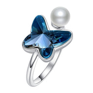 Butterfly-shaped blue Swarovski crystal ring in silver, with pearl accent on band, front view.