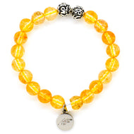 Citrine bracelet with natural yellow gemstone beads, ornate silver beads and MysticFlavia charm on white background