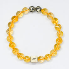 Load image into Gallery viewer, Close-up of a citrine bracelet with natural citrine round beads and a central silver infinity bead
