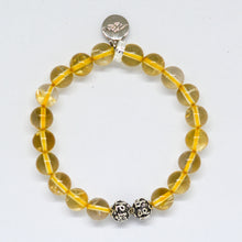 Load image into Gallery viewer, Natural yellow crystal bracelet with silver charm and patterned silver beads on a white background

