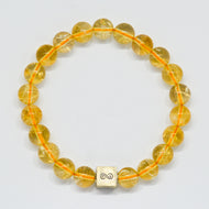 Citrine bracelet with round natural citrine beads and silver infinity bead on a white background
