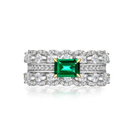 Emerald silver ring with rectangular green gemstone and sparkling stones, close-up product view