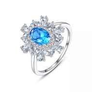 Blue topaz flower silver ring with American diamond halo design