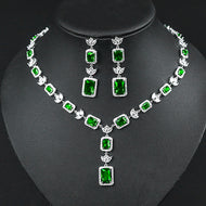 Emerald princess cut zircon silver necklace set with matching earrings on black display
