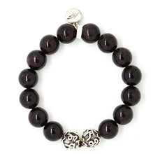 Load image into Gallery viewer, Top view of Garnet Birthstone Silver Bead Bracelet 12mm featuring natural garnet gemstone beads, 925 sterling silver designer beads, and signature charm by MysticFlavia.
