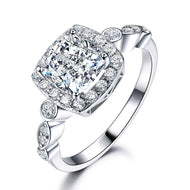 Close-up of a 925 sterling silver ring featuring a cushion-cut white gemstone surrounded by sparkling stones.