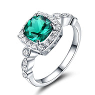 Emerald silver ring with halo American diamond setting on white background