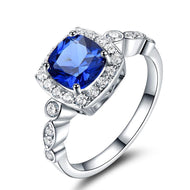 Blue gemstone cushion cut silver ring with diamond halo setting
