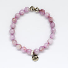 Load image into Gallery viewer, Kunzite bracelet close-up showing silver charm engraved with logo below purple beads

