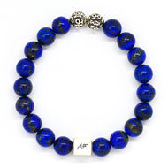 MysticFlavia lapis lazuli bracelet 8mm flat view with two engraved silver accent beads and white square brand bead on white background