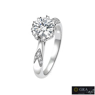 Moissanite ring with floral cluster center and pear-cut side stones in a silver setting