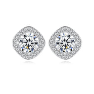 Close-up of moissanite halo stud earrings showing sparkling round centre stones with cushion-shaped pave border.