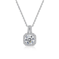 Moissanite cushion halo pendant necklace in silver, front view on white background.

