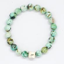 Load image into Gallery viewer, MysticFlavia turquoise bracelet with earthy green and brown marbled beads and square 925 sterling silver brand tag, white background
