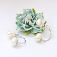Load image into Gallery viewer, Natural pearl flower hoop earrings displayed with a blue floral arrangement
