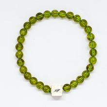 Load image into Gallery viewer, Peridot Stone Infinity Silver Bead Bracelet 8mm with 925 Sterling Silver infinity bead, flat lay product photo | MysticFlavia
