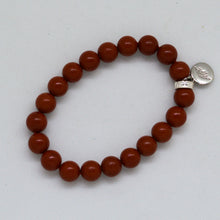 Load image into Gallery viewer, Angled view of Red Jasper Stone Flat Silver Bead Bracelet 8MM with smooth natural red jasper gemstone beads and flat sterling silver accent.
