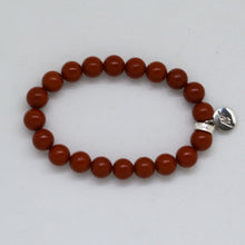 Load image into Gallery viewer, Top view of Red Jasper Stone Flat Silver Bead Bracelet 8MM featuring natural red jasper beads, flat sterling silver bead and MysticFlavia charm.
