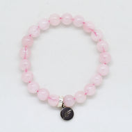 Rose quartz bracelet with flat 8mm beads and silver charm on white background by MysticFlavia