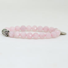 Load image into Gallery viewer, Side view of faceted natural rose quartz beads bracelet with detailed silver bead accents
