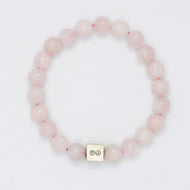 Rose quartz bracelet with 8mm round beads and infinity silver charm on white background