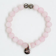 Rose quartz bracelet with matte pink beads and silver charm on white background by MysticFlavia