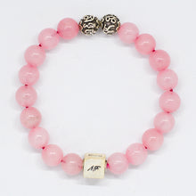 Load image into Gallery viewer, Pink natural rose quartz bead bracelet with 925 sterling silver infinity charm on white backdrop
